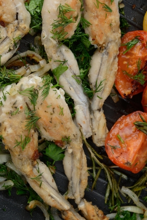 Frogs Legs Fried with Garlic and Herbs and Lemonの写真素材