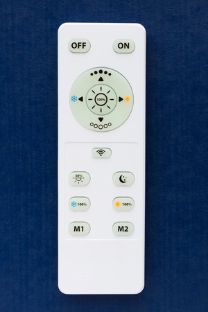 White remote control on the blue backgroundの写真素材