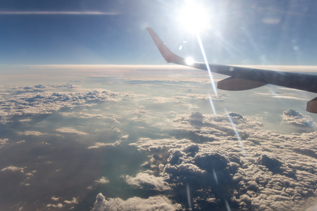 View from airplane window at the clouds in the daytimeの写真素材