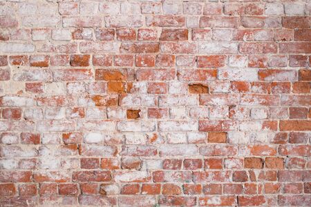 Red old brick wall background in the daytime