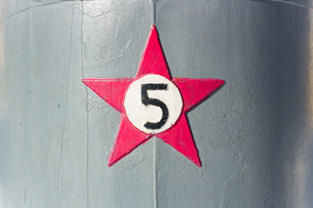 Red Star with the number five on a gray background in the dayの写真素材