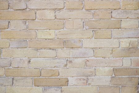 Yellow old brick wall background in the daytimeの写真素材