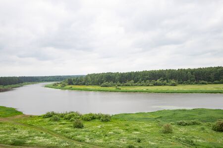 Beautiful natural scenery of river green forest meadow