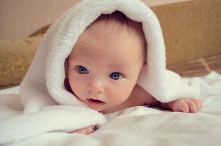 Beautiful baby portrait under blanketの写真素材