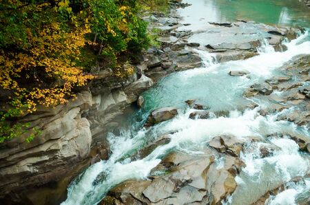 Beautiful waterfall in autumn forest - Probiy waterfall on river Prut, Carpathian, Ukraineの写真素材