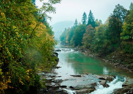 Beautiful landscape of river with waterfall in autumn forest - Probiy waterfall on river Prut, Carpathian, Ukraineの写真素材