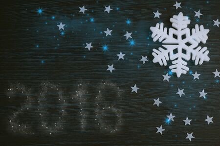White snowflake on brown wooden background. Merry christmas card. Winter holidays. Xmas theme. Happy...