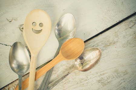 One spoon with smiley face standing with the crowd - individuality.の写真素材