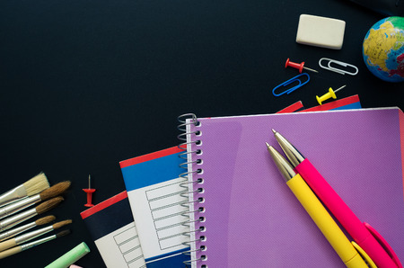 Back to school concept. School supplies on blackboard background. Back to school concept with...