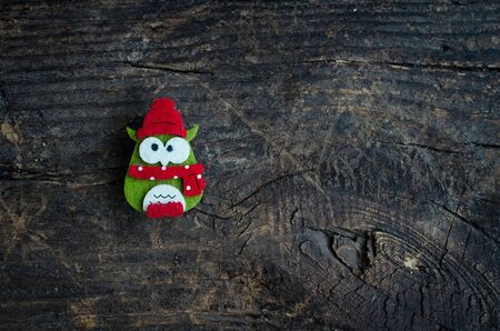 Christmas symbol owl on an old wooden background with place for text. Christmas decoration. Xmas...