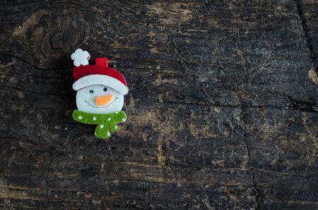 Christmas symbol snowman on an old wooden background with place for text. Christmas decoration. Xmas time background. Winter holidays. Christmas concept. Top view. Copy space.の写真素材