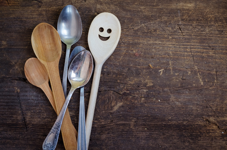 One spoon with smiley face standing with the crowd - individuality. Leadership, uniqueness, independence, initiative, dissent, think different, success, happyness, smile, positivity concept.の写真素材