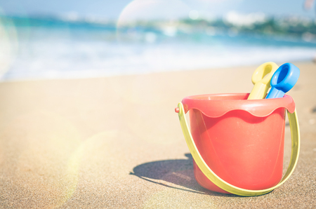Vacation image of children's beach toys on the sand in beautiful sunny day. Kids summer holidays concept. Copy space.の写真素材