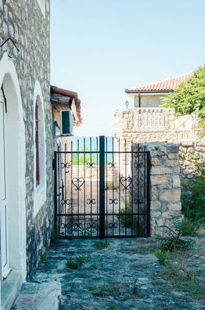 Old narrow street in Stari Grad of Ulcinj, Montenegro. The fortress in the Old town in a sunny summer day.の写真素材