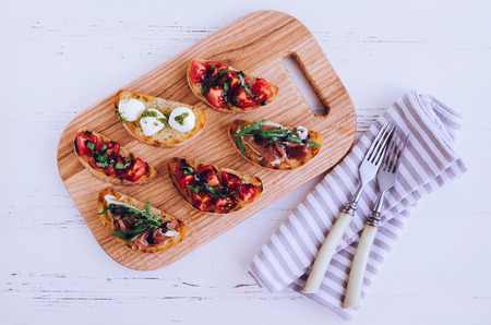 Brushetta or authentic traditional spanish tapas for lunch table. Delicious snack, appetizer, antipasti on party or picnic time. Top view, flat lay.の写真素材