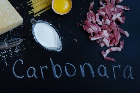 Ingredients for Pasta Carbonara on dark background with word Carbonara. Set of products for pasta...