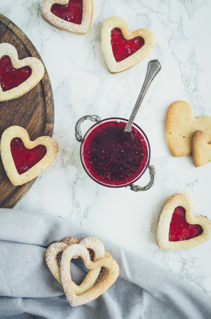 Heart shaped Linzer cookies with jam for Valentine's day.
