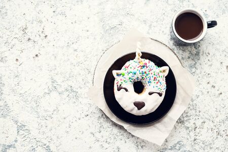 Unicorn donut with cup of coffee over light background. Happy morning breakfast concept. Holiday, romance of modern life. Mothers Day greeting card. Mother's gift. Top view. Copy space.の写真素材