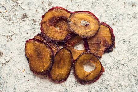 Healthy homemade fruit chips from plum on greyの写真素材