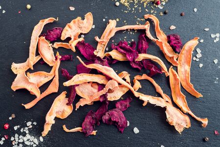 Healthy homemade vegetable chips from beetroot and carrotの写真素材