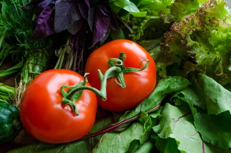 Background texture with assorted raw organic vegetables and herbs . Healthy clean eating. Different colorful vegetables on wooden table.の写真素材