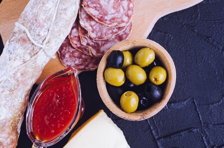 Mediterranean appetizers, tapas or antipasti on dark tableの写真素材