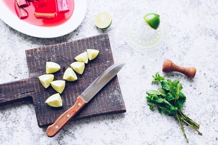 Process of making mojito cocktail with poached rhubarb. Summer refreshing drink with rhubarb, lime and mint. Rhubarb lemonade. Top view.の写真素材