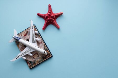 Vacation concept. Passport and plane on blueの写真素材