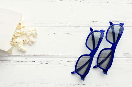 Popcorn and 3D glasses on white background. A still-life theme based on the experience of 3d movie entertainment. Top view. Copy space.の写真素材