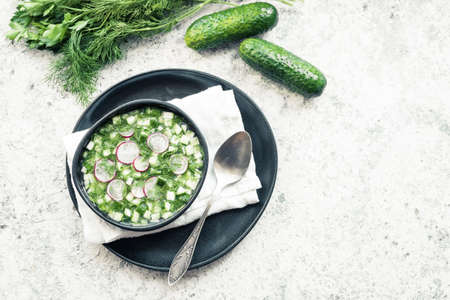 Okroshka. Traditional cold russian summer soup with radish, cucumber and dill. Top view. Copy space.の写真素材