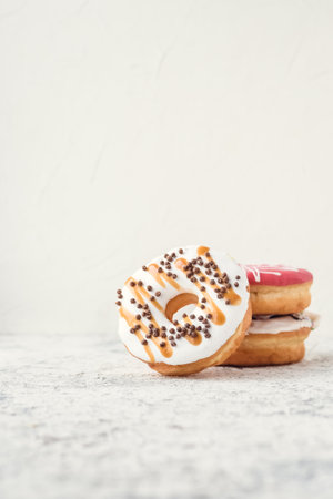 Plate with donuts over light background. Stack of doughnuts. Copy space.の写真素材