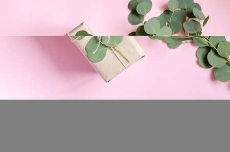 Gift box wrapped in brown paper decorated with eucalyptus branch, natural eco friendly zero waste gift wrapping idea. Top view.の写真素材