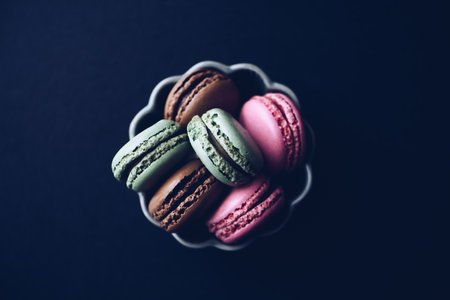 Macaroons on dark background, colorful french cookies macaroonsの写真素材