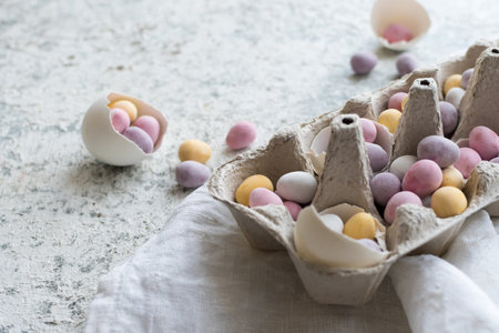 Easter composition with mini chocolate eggs in pastel colorsの写真素材