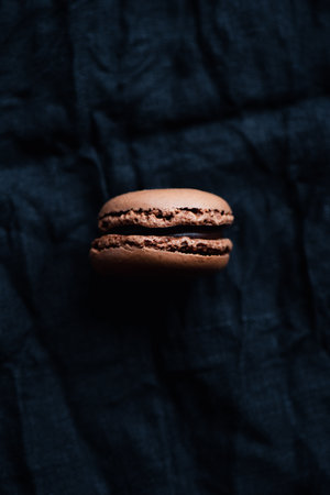One macaroon on dark background, chocolate french cookies macaroonsの写真素材