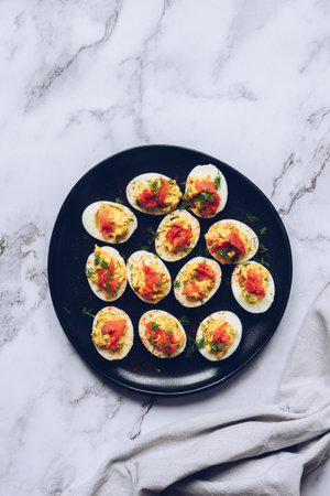 Stuffed deviled eggs with salmon and mayonnaise. Easter food concept, spring flowers, easter bunny....