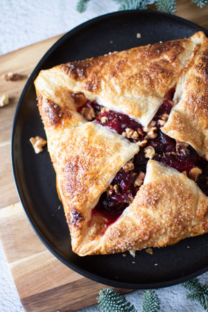 Baked brie cheese and cranberry puff pastry. Homemade puff pastry baking, sweet-savory taste,...
