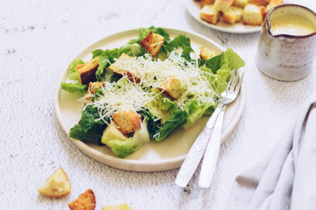 Classic caesar salad with lettuce, croutons and parmesan cheeseの写真素材