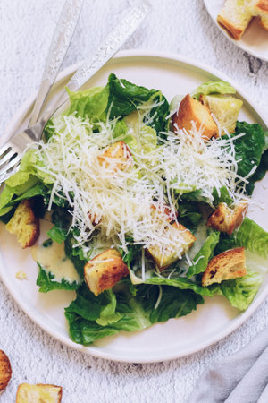 Classic caesar salad with lettuce, croutons and parmesan cheeseの写真素材