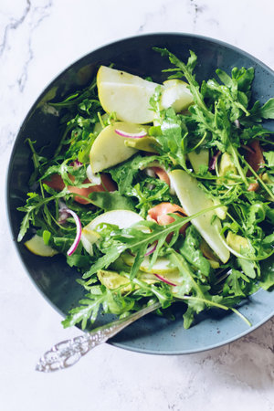 Healthy salad with arugula, smoked salmon, pear, avocado and red onionの写真素材