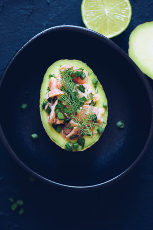 Healthy salad with avocado, smoked salmon, green onion and dill