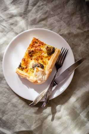 Sliced traditional french open quiche pie with cheese and broccoliの写真素材