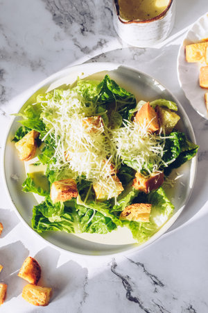 Classic caesar salad with lettuce, croutons and parmesan cheeseの写真素材