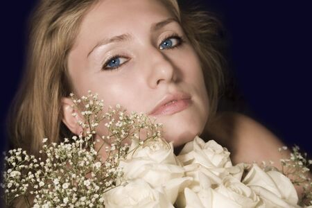 beautiful woman with a bouquet of rosesの写真素材
