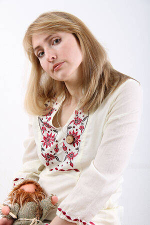 Woman in a white blouse with a toyの写真素材