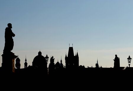 Sunset over Prague, Charles Karlov Bridge is famous attraction, world heritage site. Historic place of capital of Czech Republic, cultural center of Europe. Gothic, Renaissance and Baroque eras.の写真素材