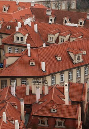 Prague roof tops. Aerial view of old terracotta roof tiles in Prague from top of city hall. Beautiful European cityescapeの写真素材