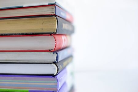 Stacked old books from cover side, soft focus, close up. Learning, reading, adventure of curiosity.