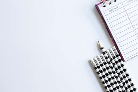 Weekly organizer planner, shaper and sharp pencil surrounded by dull pencils. Stationery flat lay. Back to school. White background. Business, sharp idear concept. Mock upの写真素材