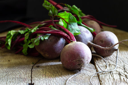 Bunch of fresh, spring, organic beetroot on old wooden background. Horisontal view. Rustic, dramatic, organic kitchen. Ingredients, menu. Healthy life, diet conceptの写真素材